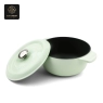 A light green enamel cast iron Dutch oven with its lid partially open, showing the black interior.