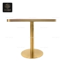 A side view of a rectangular coral table top with a decorative pattern and gold base.
