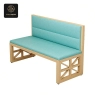 light-wood framed booth with light-blue cushioned seating and backrest.