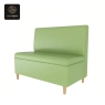 light-green upholstered sofa with light-wood legs and high back.