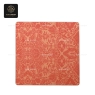 An overhead view of a square table top with a coral decorative pattern.