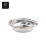 A divided round chafer dish with a hammered silver interior and golden rim.