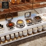 A buffet spread featuring various stainless steel electric chafing dishes.