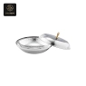 This hammered silver serving bowl has a textured interior and a lid with a golden handle.
