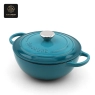 A front-view of a light blue, heart-shaped enamel cast iron dutch oven with a lid.