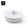 An artistic overhead shot of the heart-shaped knob on the lid of a white speckled pot.