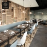 A restaurant with round marble-top tables and stylish dining chairs.