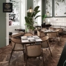 A long, white marble table with a dark brown central base and matching chairs.