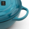 Close-up of the heart-shaped knob on a light blue enamel cast iron dutch oven lid.