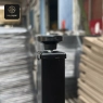 A close-up of the adjustable foot on a black metal table leg.