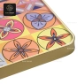 A close-up of the golden edge and some of the colorful patterns on the table top.