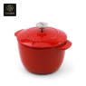 A front view of a red, pumpkin-shaped enamel cast iron dutch oven with a lid.