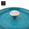 A close-up view of the metal knob on the blue enamel dutch oven's lid.