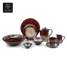 A complete set of Plum Wave deep purple kiln-glazed dinnerware: plates, bowls, teapot, and cups.