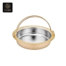 A golden hot pot with a hammered silver interior and a large handle.