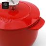 An overhead shot captures the unique stem-shaped knob and a portion of the lid on the red pot.