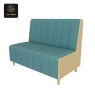 A single two-seater booth with a light-wood frame and blue vertical-channeled upholstery.
