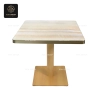 A bistro table with a gray marble top and a black central base.