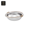 A round chafer dish with hammered silver interior, golden rim, and accents.