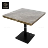 A round white stone tabletop with a polished gold central base.