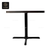 A side view of the dining table, showing the dark table top and the black pedestal base.