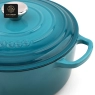 A blue enamel cast iron dutch oven with a lid embossed with the word 'Success'.