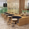 Restaurant with curved wood and navy upholstered booths and unique hanging decor.