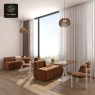 A bright and airy cafe with modular sofas, modern chairs, and large windows with sheer curtains.
