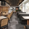 A restaurant setting with multiple round marble-top bistro tables and chairs.
