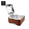 This electric chafing dish showcases its clear lid, ergonomic handle, and food warming capabilities.