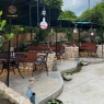 RON GROUP Outdoor Restaurant Design with Stone Walls and Greenery