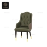 A dark green high-back armchair with a tufted back and patterned brown sides.