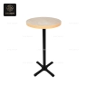 A round, light-wood top bar table with a polished silver central base.