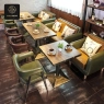 A cafe scene featuring green and brown leatherette seating with wooden tables.