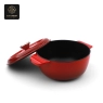 A red enamel cast iron dutch oven with its lid propped open.