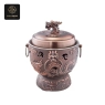 This copper-finished induction cooker features intricate dragon designs and a dragon head lid handle.