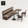 Two round stone tables and a long wooden bench with cushioned seats.