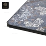 A close-up of a corner of the decorative table top with intricate patterns.