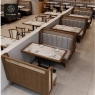 An aerial view of a restaurant's dining area with booths and marble tables.