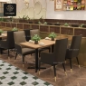 Beige high-back armchairs with dark sides in a restaurant setting.