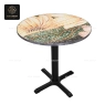 A round mosaic table top on a black cross-style table base.