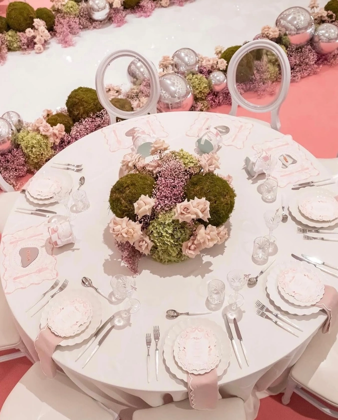 Luxury floral banquet table setup with RON GROUP tableware and seating