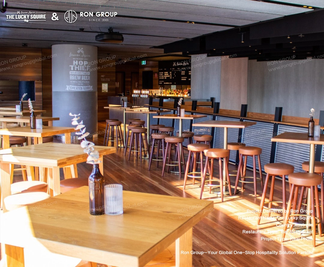Wooden high tables and bar stools with leather seats strategically placed in the taproom