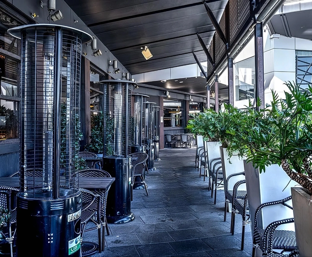Outdoor terrace at Volcano's Steakhouse Outdoor patio dining area at Volcano's Steakhouse with commercial chairs, tables, and freestanding heaters