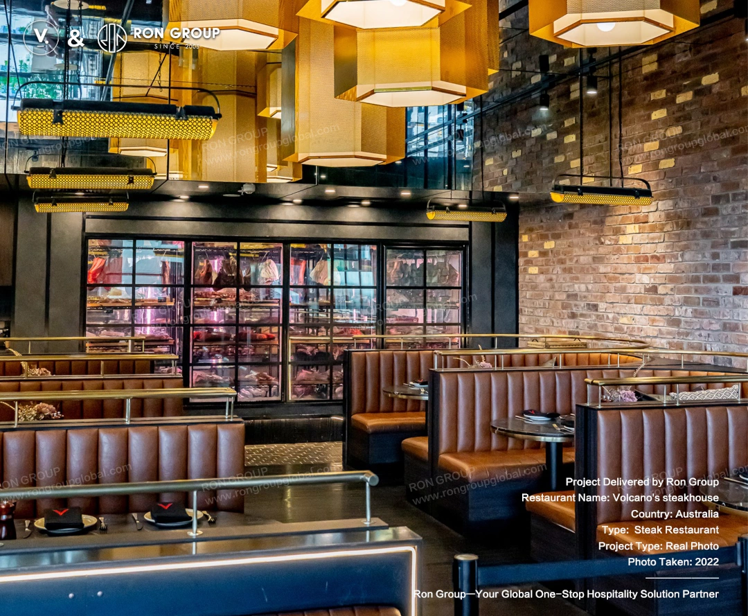 Dry-aging feature area at Volcano's Steakhouse Custom booth seating and dramatic lighting surrounding the dry-aging meat display at Volcano's Steakhouse