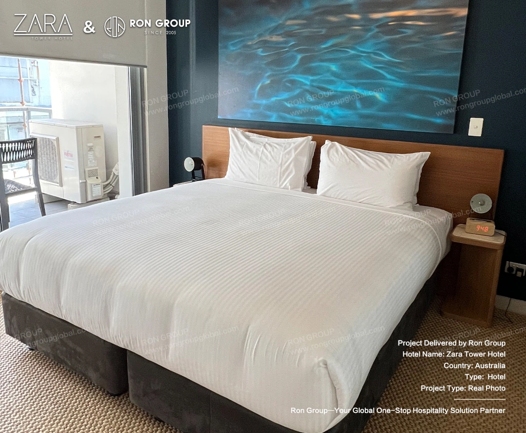 Upscale bedroom layout overlooking the city skyline, featuring modern furniture and floor-to-ceiling windows