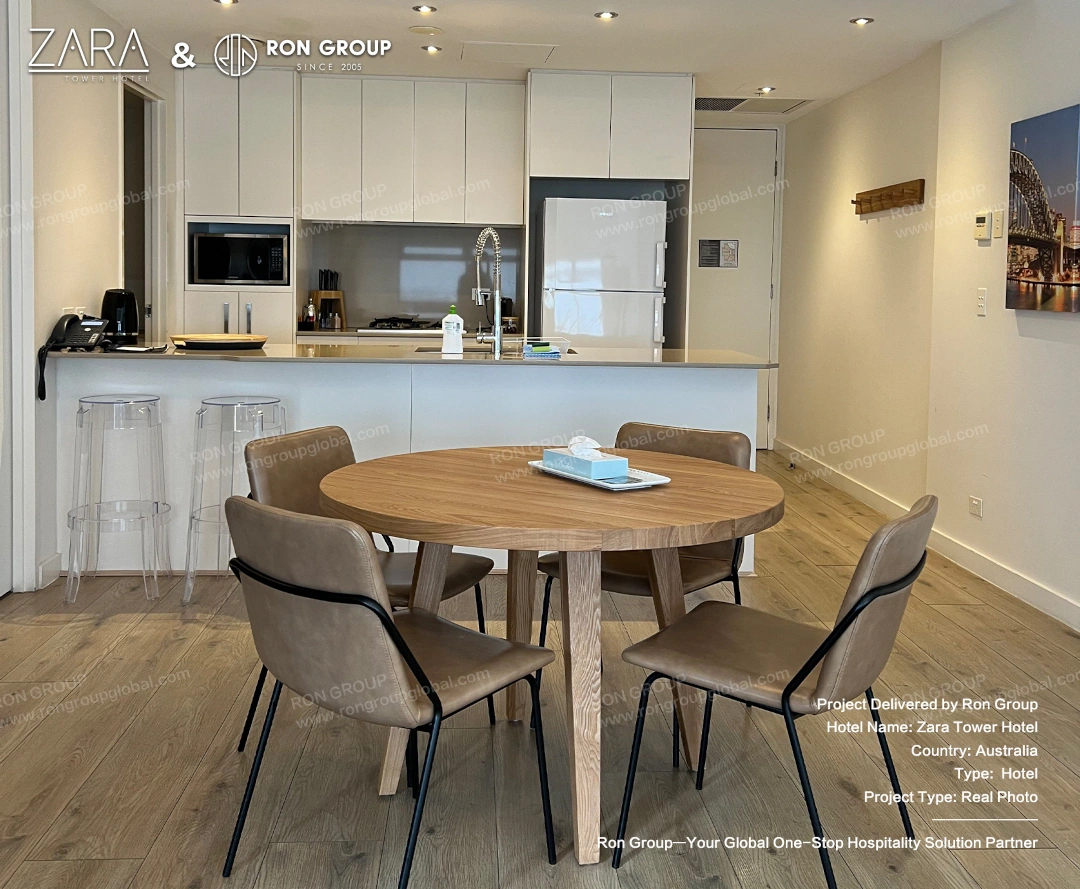 A bright kitchen area with modern bar stools and a sleek dining table setup