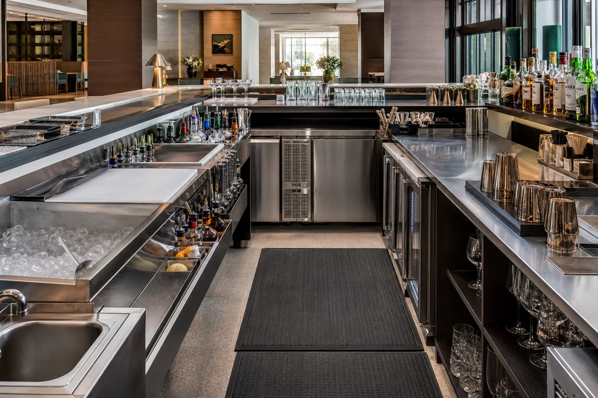 Complete commercial bar workstation with ice bin, sink, refrigeration, and glass storage